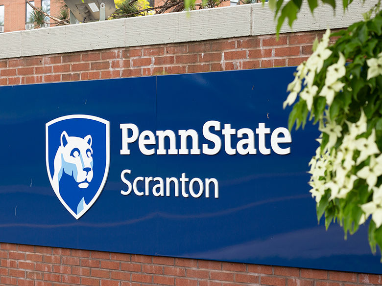 Blue Penn State Scranton sign on brick entrance way.